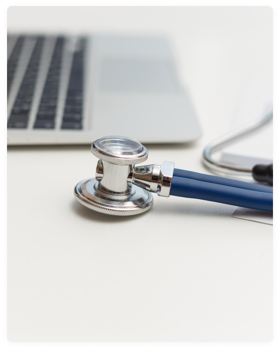 stethoscope and laptop on doctor working desk