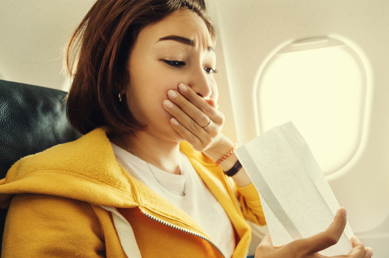 Young lady with yellow jacket having motion sickness on planes