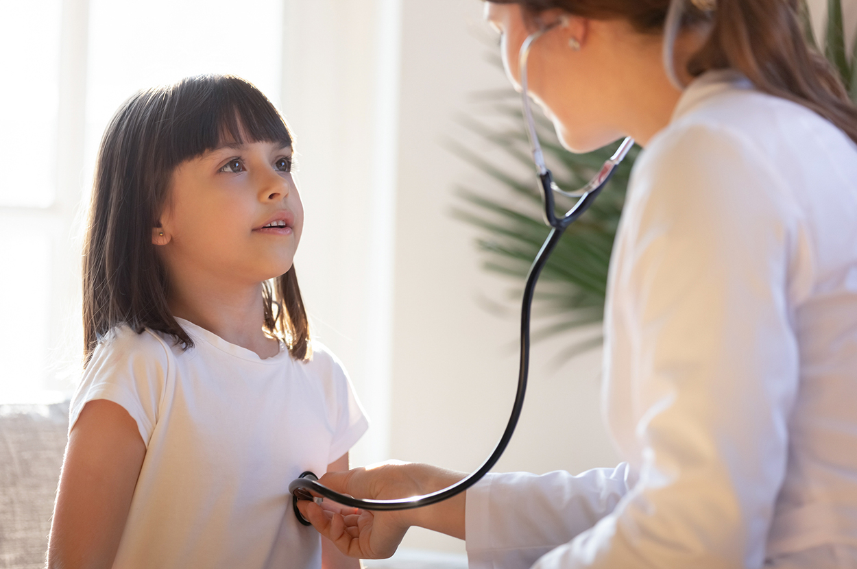 Physician checking the child with her stethoscope